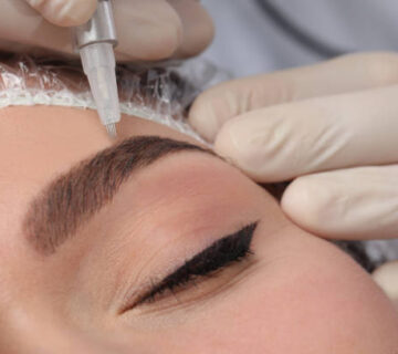 Young woman during procedure of permanent eyebrow makeup, closeup